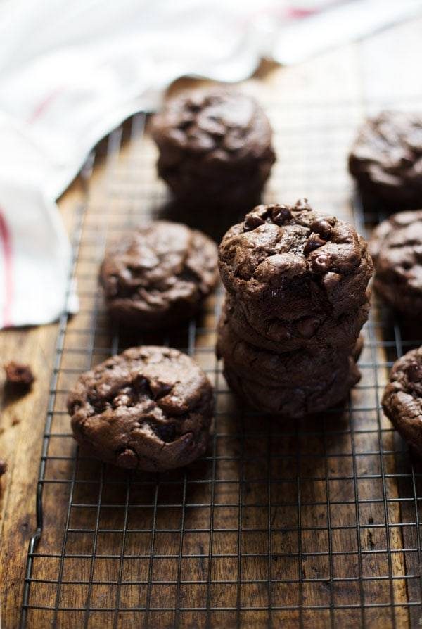 Double Chocolate Cookies stacked on each other on a drying rack.