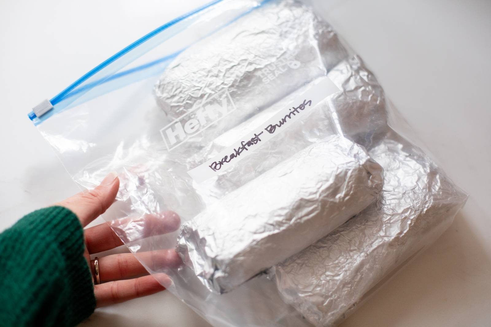 Frozen breakfast burritos in a plastic bag.