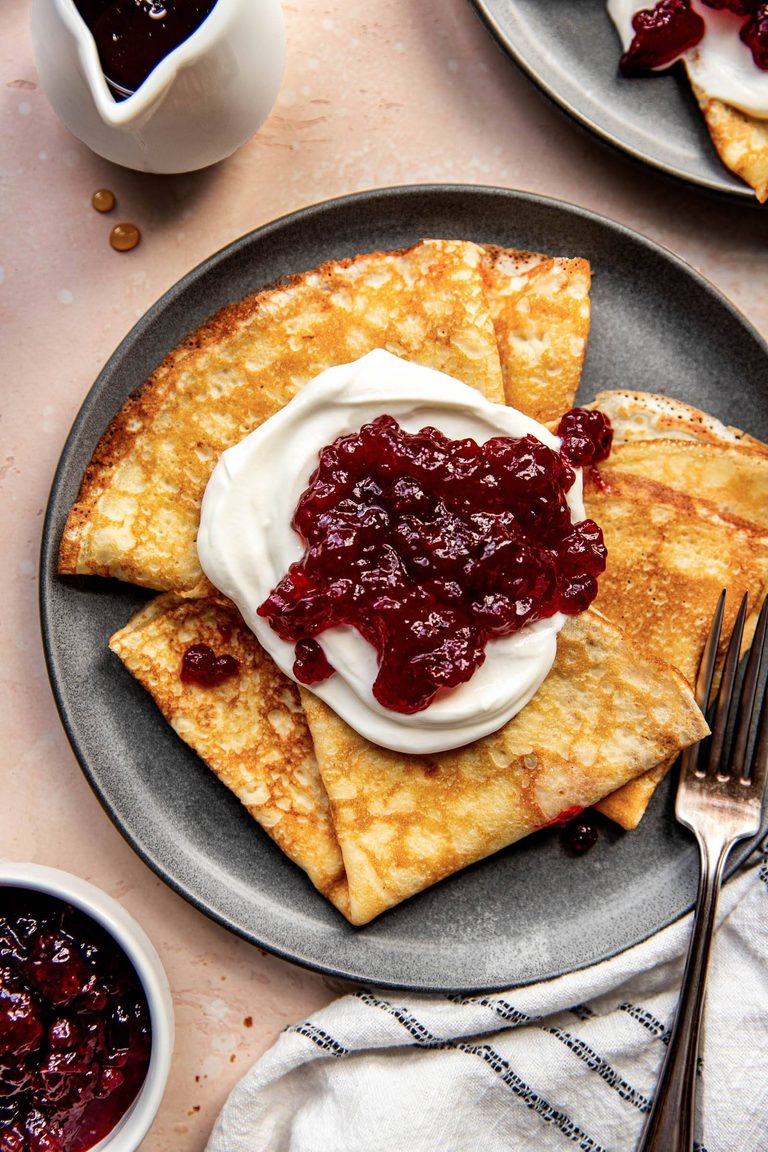 Swedish pancakes topped with lingonberries.