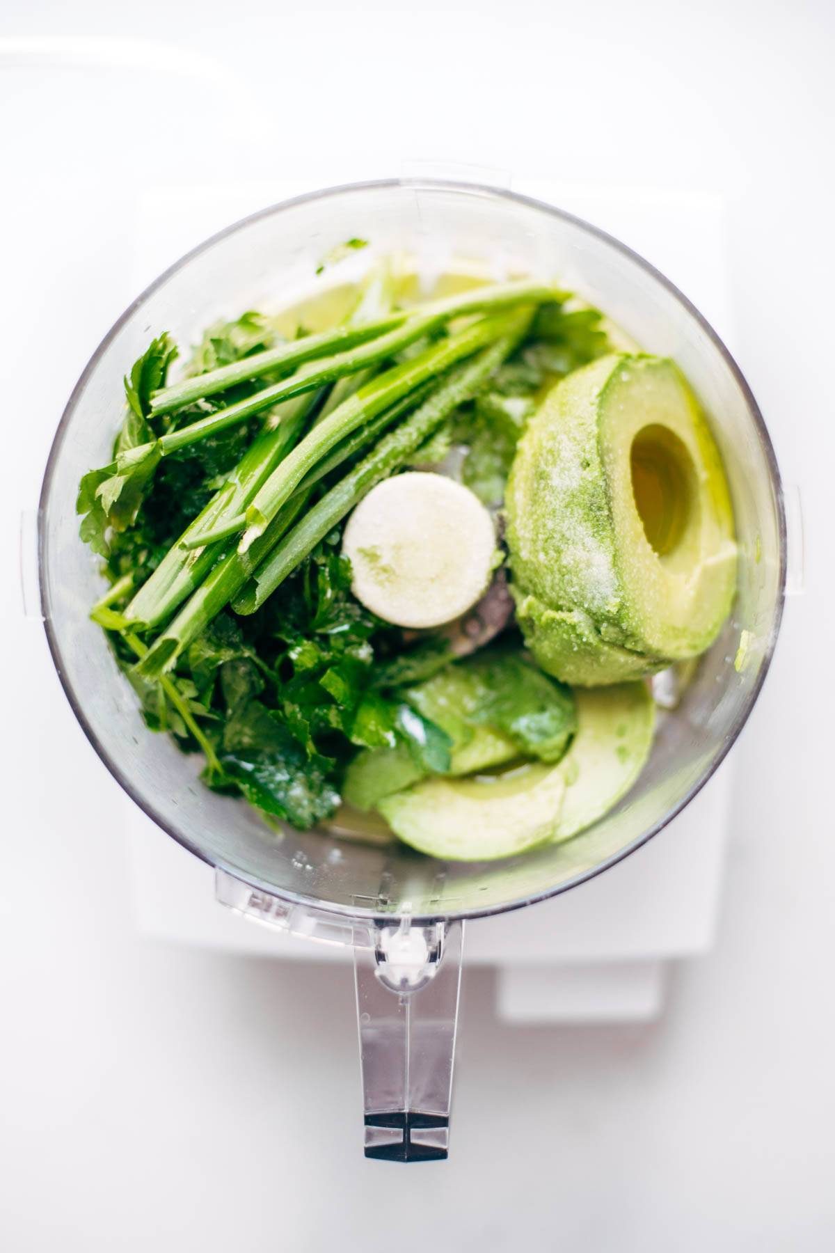 Onions, cilantro, and avocado in a food processor.