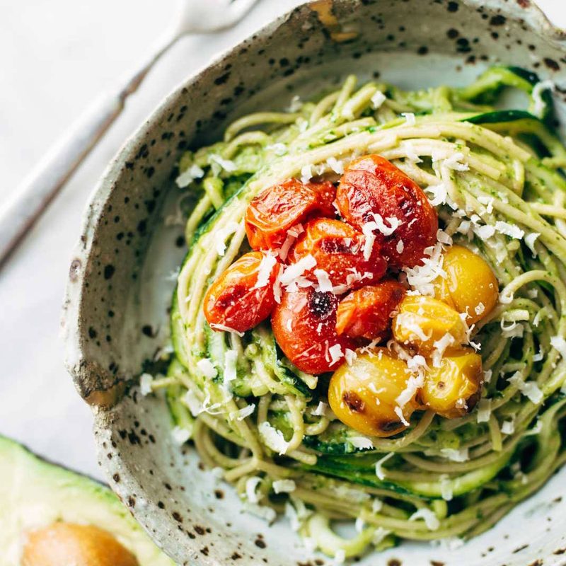 Zucchini spaghetti with tomato topping in a bowl.